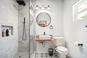 a bathroom with a shower and a toilet and a mirror at 1BR Apt 8 mins St Anthony, Unit B in Oklahoma City