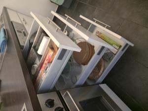 an overhead view of an open refrigerator with its shelves at TechisFerienWohnung in Magdeburg +3 photos
