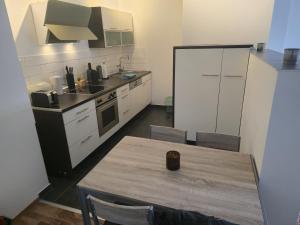 a kitchen with a table and a kitchen with a stove at TechisFerienWohnung in Magdeburg