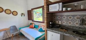 a small room with a small bed in a kitchen at Sítio Roda d'Água in Lagoa Santa