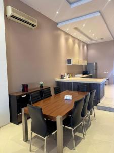 a dining room with a wooden table and chairs at درة العروس ريفيرا in Durat Alarous +14 photos