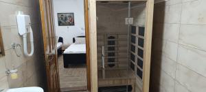 a bathroom with a door leading to a bedroom at Petrovaradinski Dvor in Petrovaradin +114 photos