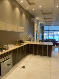 a kitchen with wooden cabinets and a counter top at درة العروس ريفيرا in Durat Alarous