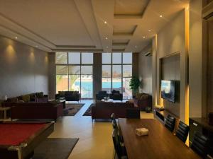 a living room with a pool table and couches at درة العروس ريفيرا in Durat Alarous