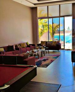 a living room with couches and a pool table at درة العروس ريفيرا in Durat Alarous