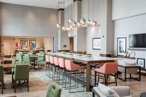 a dining room with a long table and chairs at Hampton Inn & Suites St. George in St. George