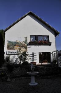 a white house with a painting on the side of it at Apartment Edelweiß in Egsdorf