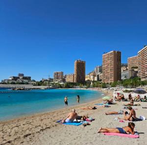 a group of people laying on the beach at Casa Bellevue in Beausoleil