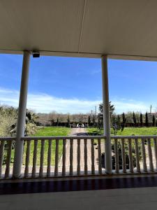 a view from a porch with a view of a field at Fireside Fiesta Haven in Maglaki