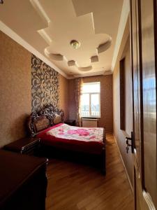 a bedroom with a bed with a red comforter and a window at Fireside Fiesta Haven in Maglaki +9 photos