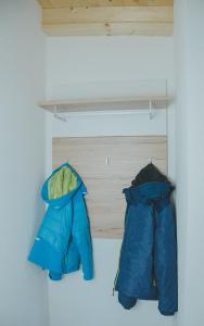 two jackets are hanging on a shelf in a room at Apart Kaunergrat in Kauns