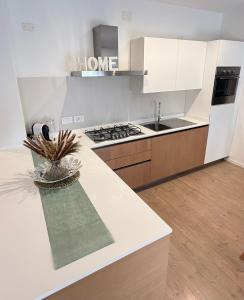 a kitchen with a white counter top and a sink at Al Nio in Baselga di Pinè