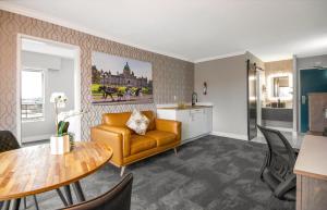 a living room with a couch and a table at The Vic, an Ascend Collection Hotel in Victoria