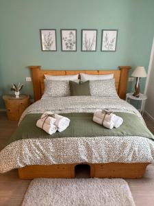 a bedroom with a bed with two towels on it at Al Nio in Baselga di Pinè