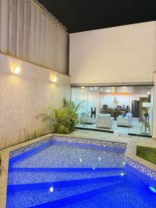 a swimming pool in a room with a house at Pool house, garden, grill in Ica +21 photos