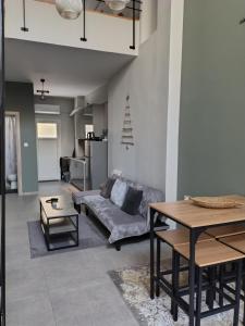 a living room with a couch and a table at Konstantinos Loft in Serres