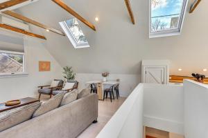 a living room with a couch and a table at Steps to NYC Train! Charming Carriage House Loft in Glen Ridge