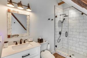 a bathroom with a sink and a shower at Steps to NYC Train! Charming Carriage House Loft in Glen Ridge