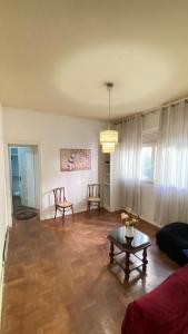 a living room with a couch and a table at VILA LEME Casa 11A in Rio de Janeiro