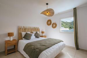 a bedroom with a large bed and a window at Appartement Reflets Marins in Saint Martin +25 photos