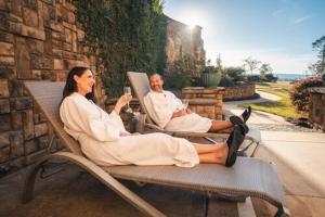 a man and woman sitting in chairs on a patio at Callaway Resort & Gardens in Pine Mountain
