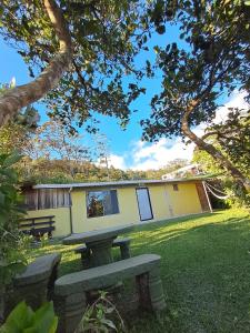 a house with a bench in front of it at Monteverde Cecropia Paradise in Monteverde Costa Rica