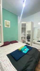 a bedroom with a bed with a blue wall at VILA LEME Casa 11A in Rio de Janeiro