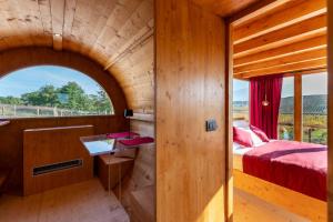a bedroom in a tree house with a bed and a window at Ámpelos Wine Room in Gallo