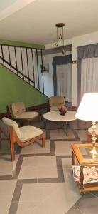 a living room with chairs and tables and a green wall at Hotel San Martín in Santa Rosa