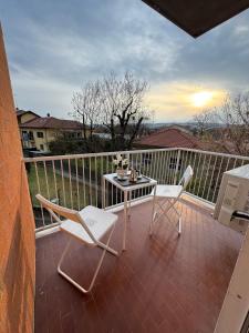 a patio with a table and chairs on a balcony at Great Sweet Home in Strambino