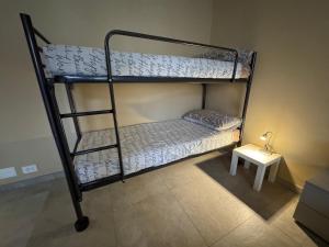 two bunk beds in a room with a side table at Great Sweet Home in Strambino