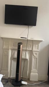 a television monitor sitting on top of a fireplace at Studio Luxe on Chudleigh D in London