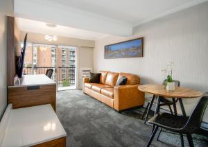 a living room with a couch and a table at The Vic, an Ascend Collection Hotel in Victoria