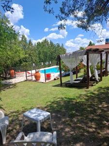 a backyard with a pool and a gazebo at Cabañas Thijada in Mina Clavero