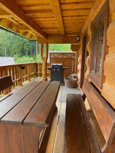 a wooden bench on a porch of a log cabin at Drevenica u Michala in Terchová