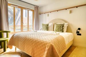 a bedroom with a large bed and a window at Paris La Belle - Lafayette in Paris