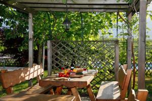 a wooden table with food on it on a patio at Fischerhof Agriturismo in Cornaiano