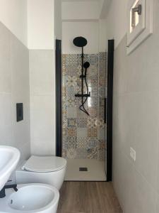 a bathroom with a toilet and a shower at Hotel Sylva in Cattolica