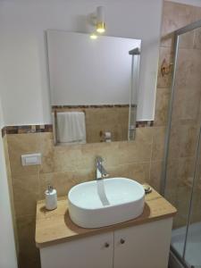 a bathroom with a white sink and a shower at Villa Arcadia Hotel & Eventos Cusco in Cusco +147 photos