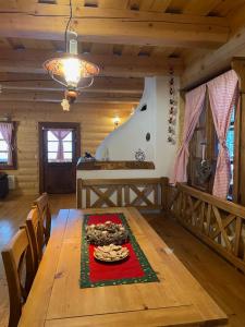a dining room with a wooden table in a cabin at Drevenica u Michala in Terchová