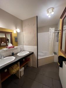 a bathroom with two sinks and a shower at A L’Abri Du Loup in Roquefort-sur-Garonne +56 photos