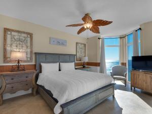 a bedroom with a bed with a ceiling fan and a television at Jade East Towers 0640 by Newman-Dailey in Destin
