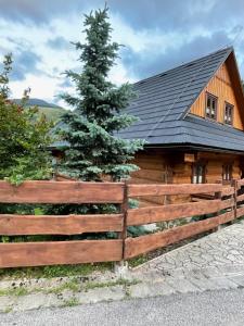 a wooden fence in front of a log cabin at Drevenica u Michala in Terchová