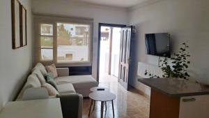 a living room with a couch and a tv at Iris 25 in Playa Blanca