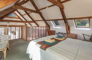 a bedroom with a bed in a room with wooden ceilings at Putham Barn Cutcombe in Wheddon Cross