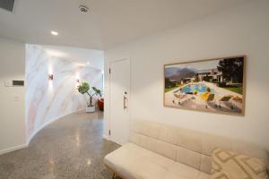 a living room with a couch and a painting on the wall at 19th Avenue on the Beach in Gold Coast