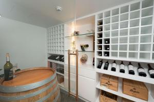a wine tasting room with a barrel and wine bottles at 19th Avenue on the Beach in Gold Coast