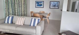 a living room with a couch and a table at Port Elliot Beachcomber on Horseshoe Bay linen included spotless in Port Elliot