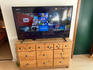 a television on top of a wooden dresser at Ferienwohnung Relax 1 in Hahnenklee-Bockswiese