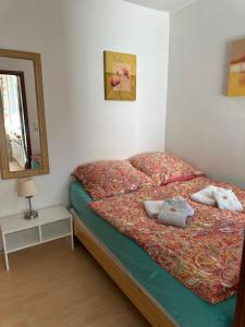 a small bedroom with a bed with a mirror and a mirror at Ferienwohnung Relax 1 in Hahnenklee-Bockswiese